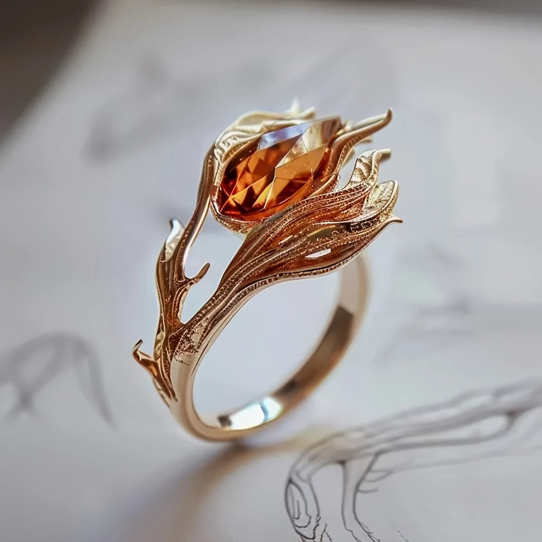 Guld ring med orangefarvet krystal